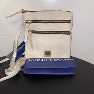 Dooney & Bourke Triple Zip Crossbody. White w Red Lining. Has registration card